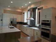 A kitchen with white cabinets and stainless steel appliances.
