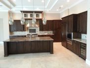 It is a kitchen with a large island in the middle of it.