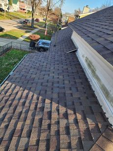 The roof of a house with a car parked on the side of it.