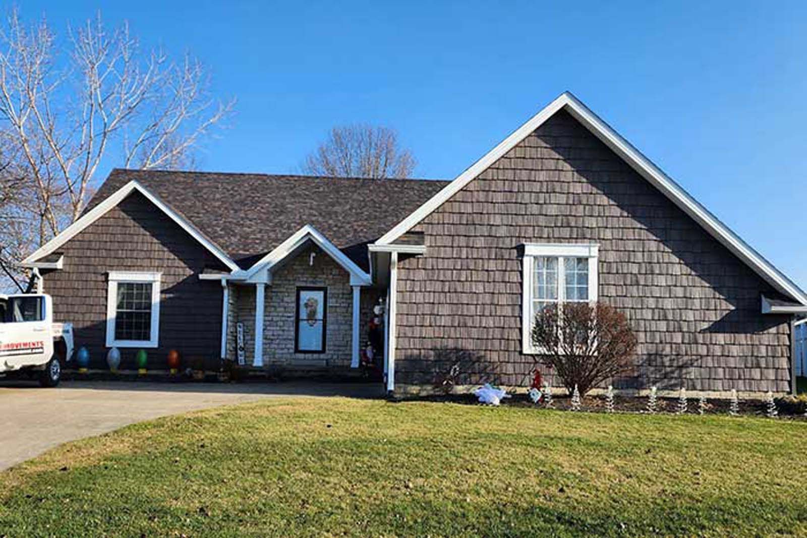 A large house with a truck parked in front of it.