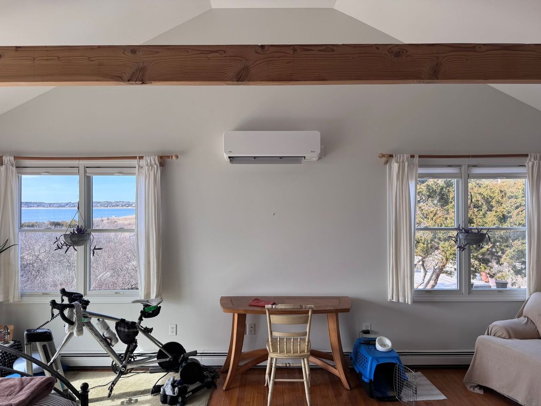 A room with a desk and a bicycle in it