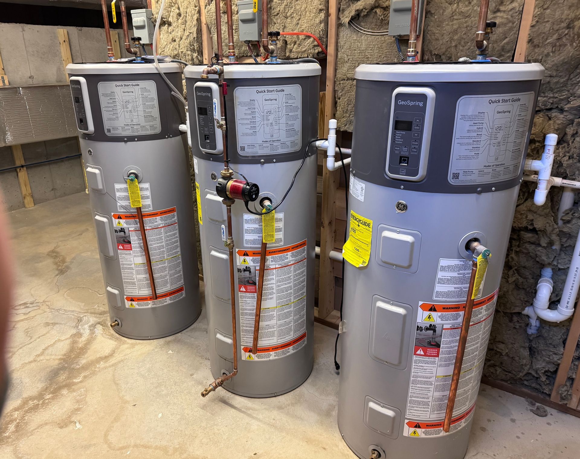 A room filled with lots of pipes and a boiler.