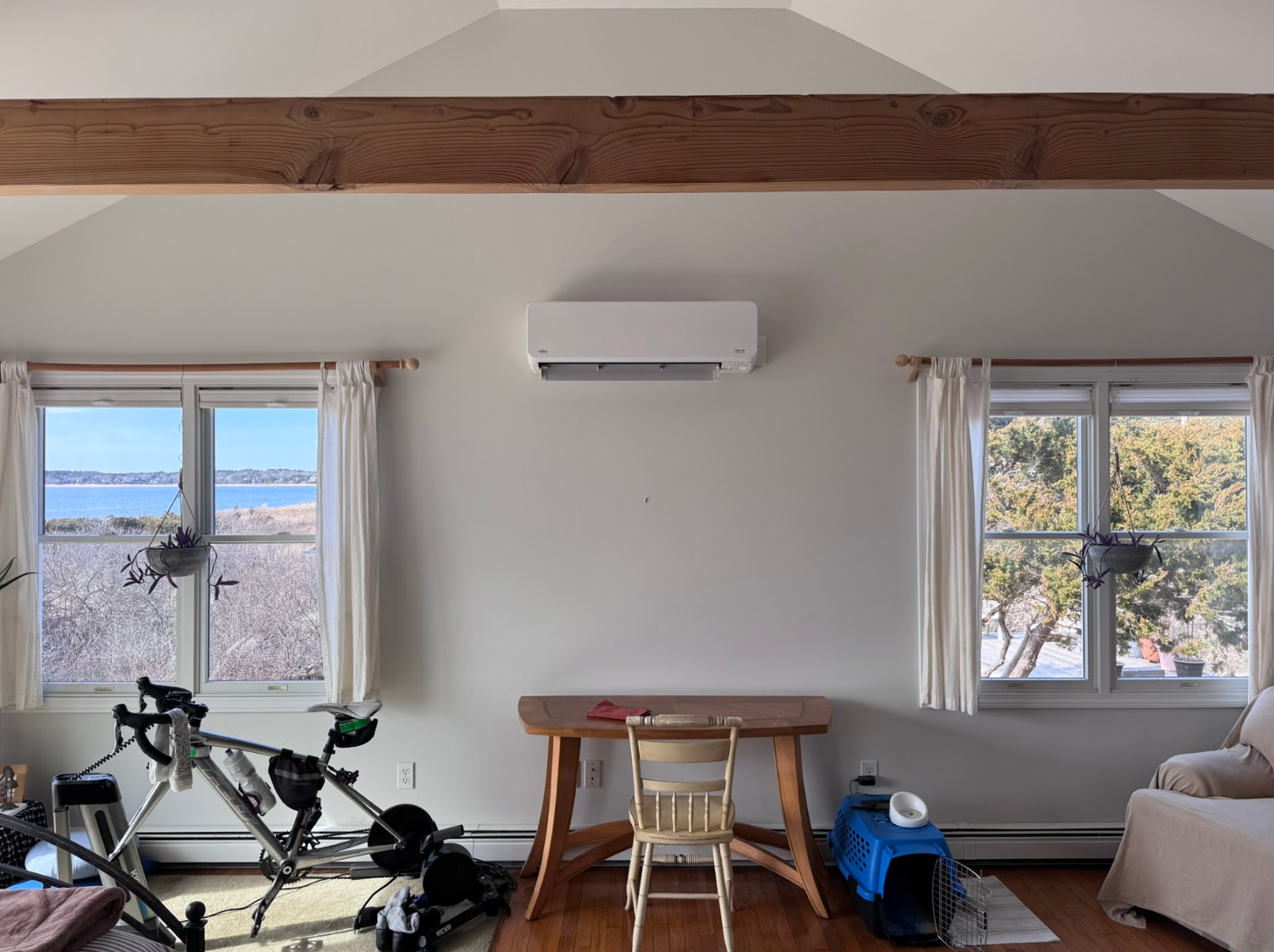 A room with a desk and a bicycle in it