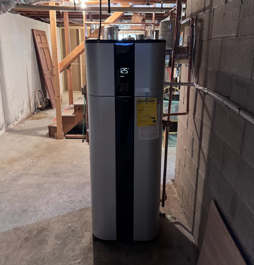 A water heater in a basement with the number 25 on it