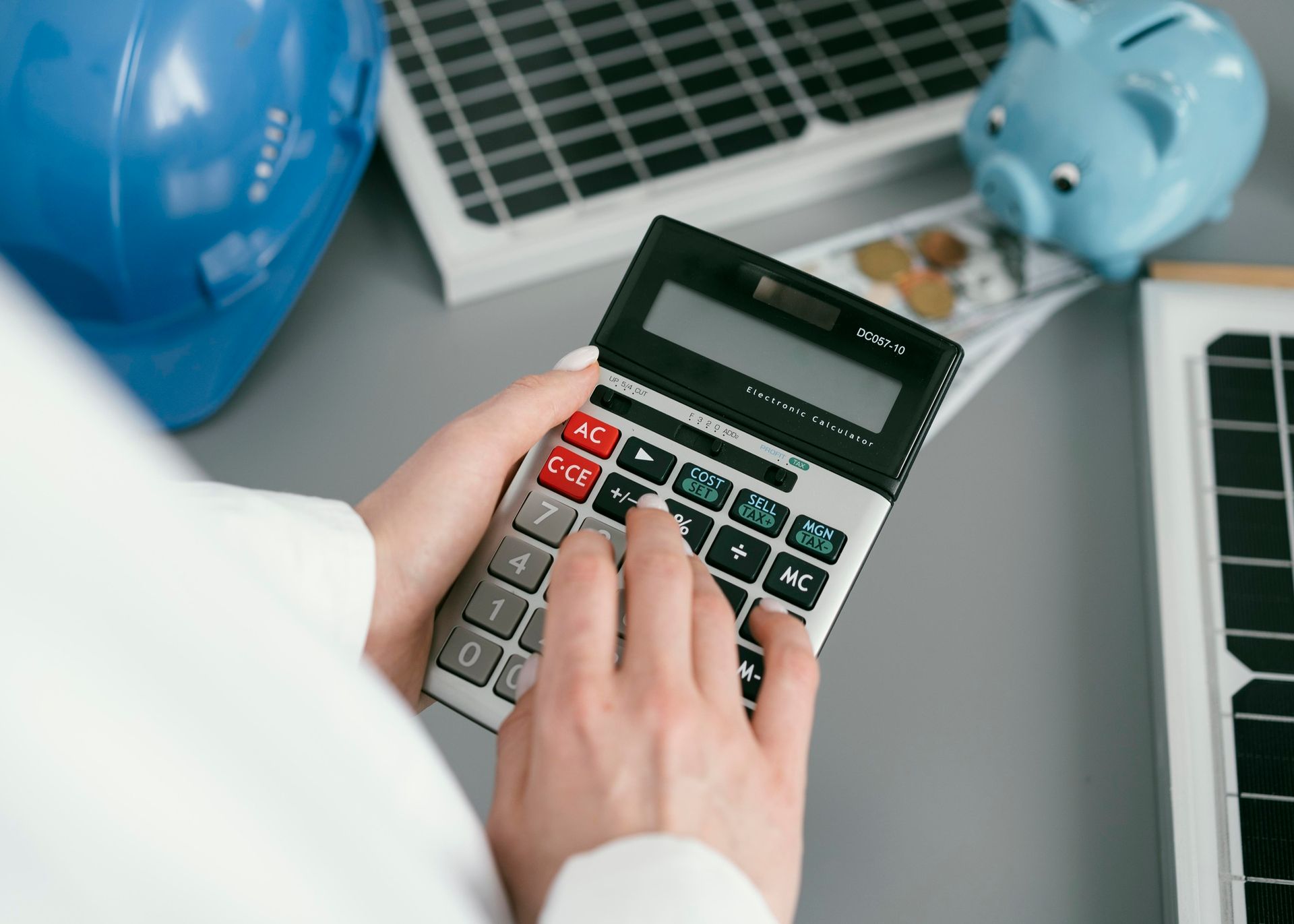 A person is holding a calculator in their hands.
