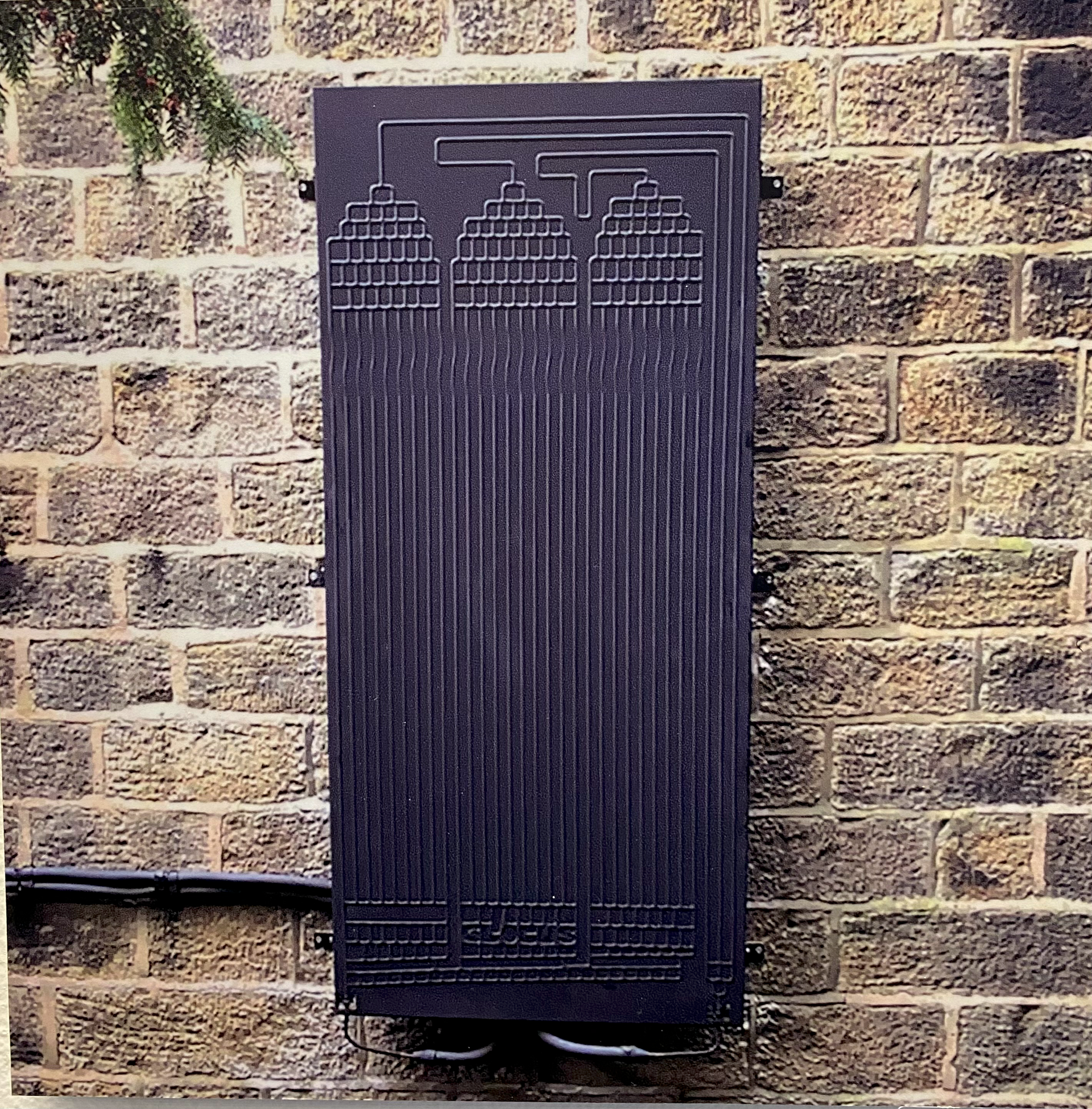 A brick wall with a black box on it