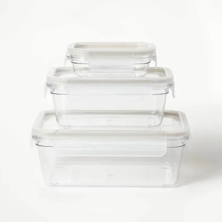 Three clear plastic containers with white lids are stacked on top of each other.