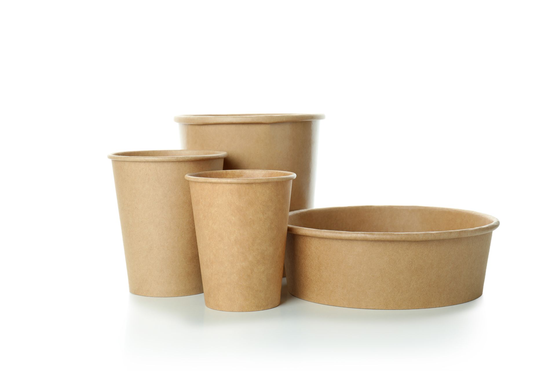 A group of brown paper cups and bowls on a white background.