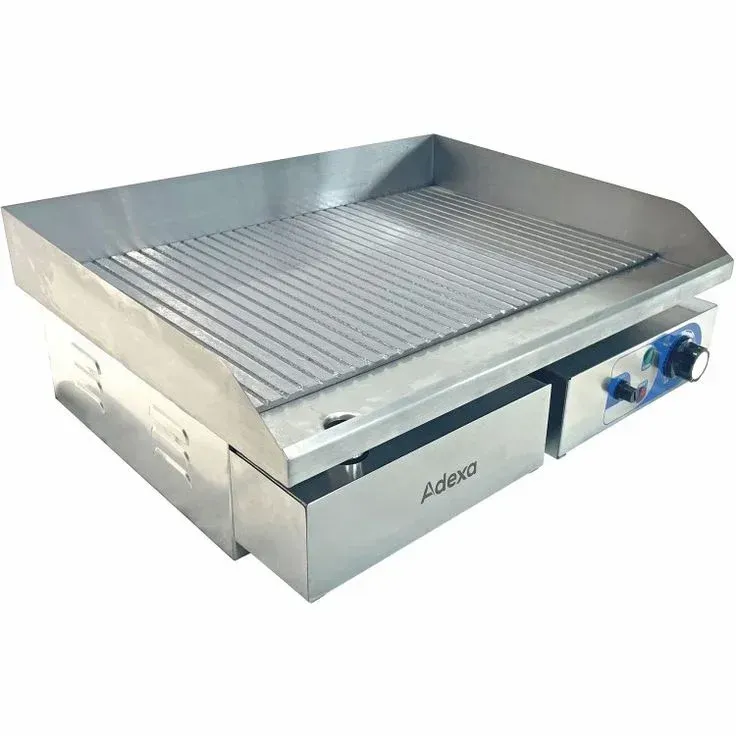 A stainless steel griddle is sitting on a white surface.