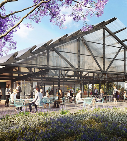A group of people are sitting at tables outside of a building.
