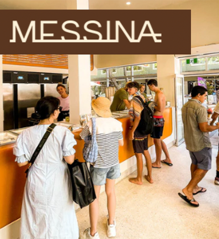A group of people standing in line at messina