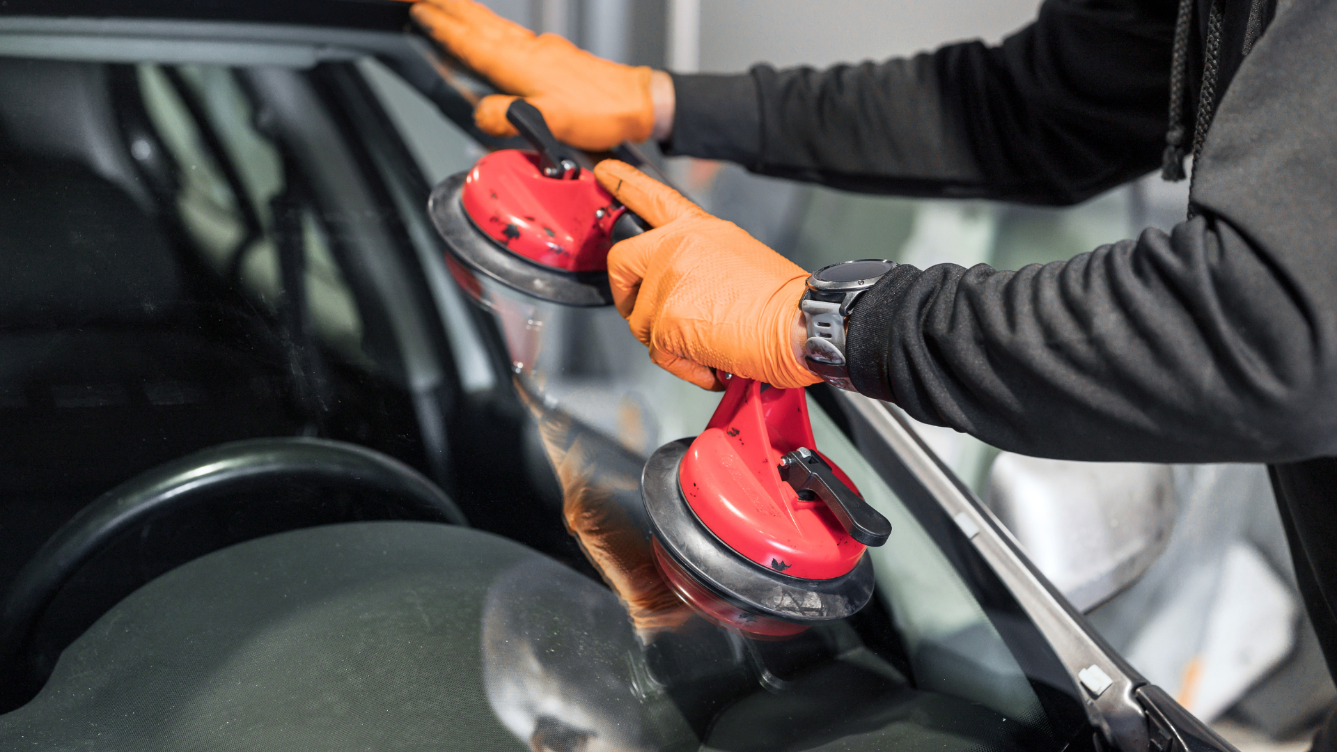 mechanic replacing a windshield