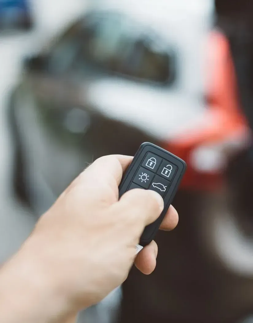man holding fob to car