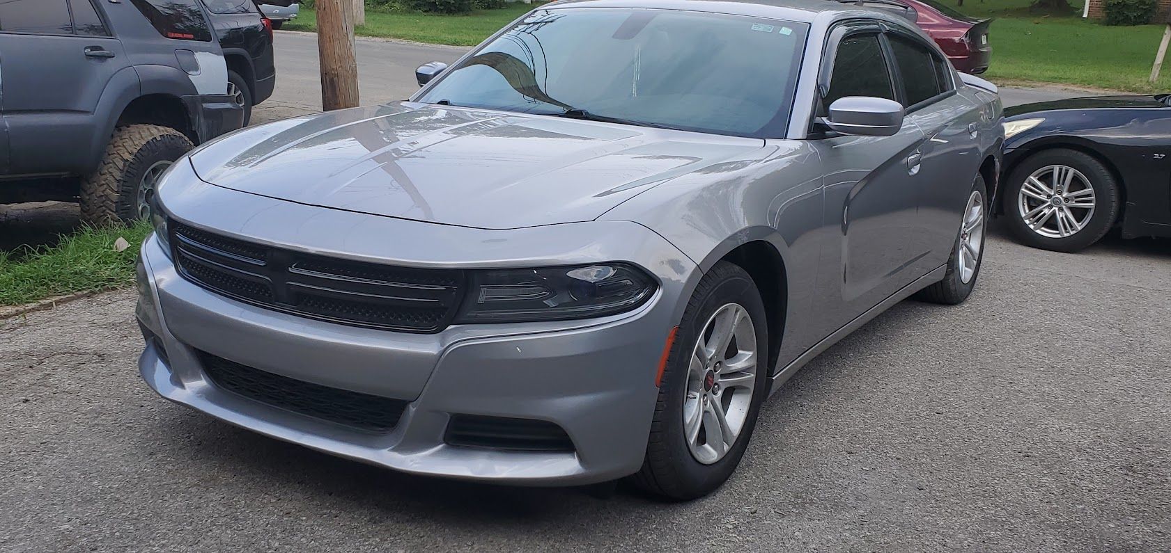 Gray Dodge Charger parked on a driveway, front-left view