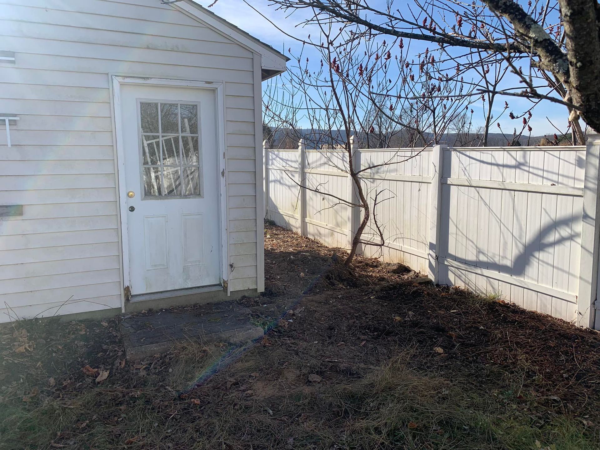 A white house with a white fence and a white door
