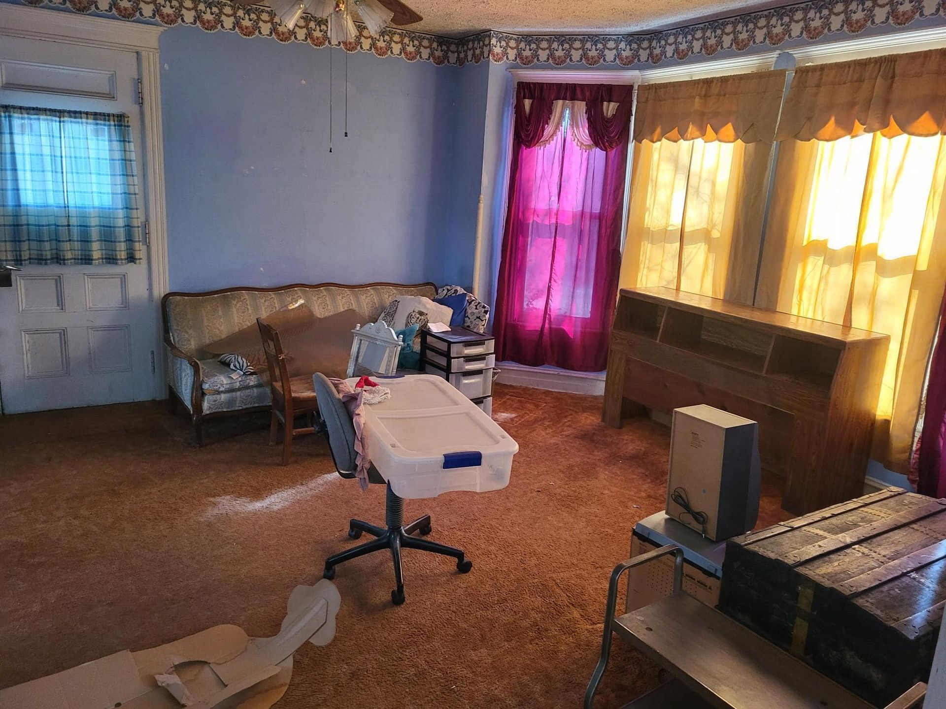 A living room with a couch and a desk