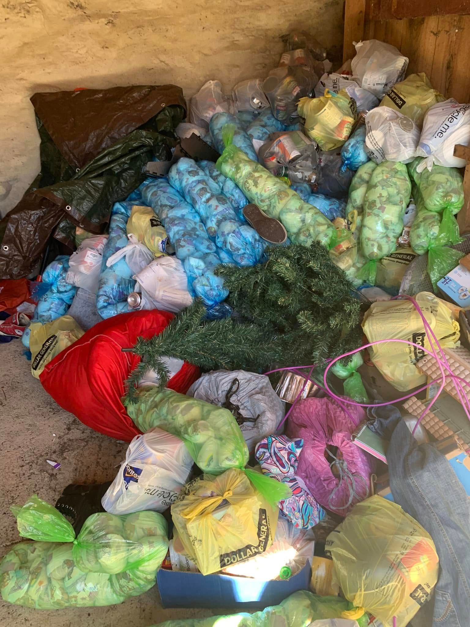 A pile of trash is sitting on the ground in a room.