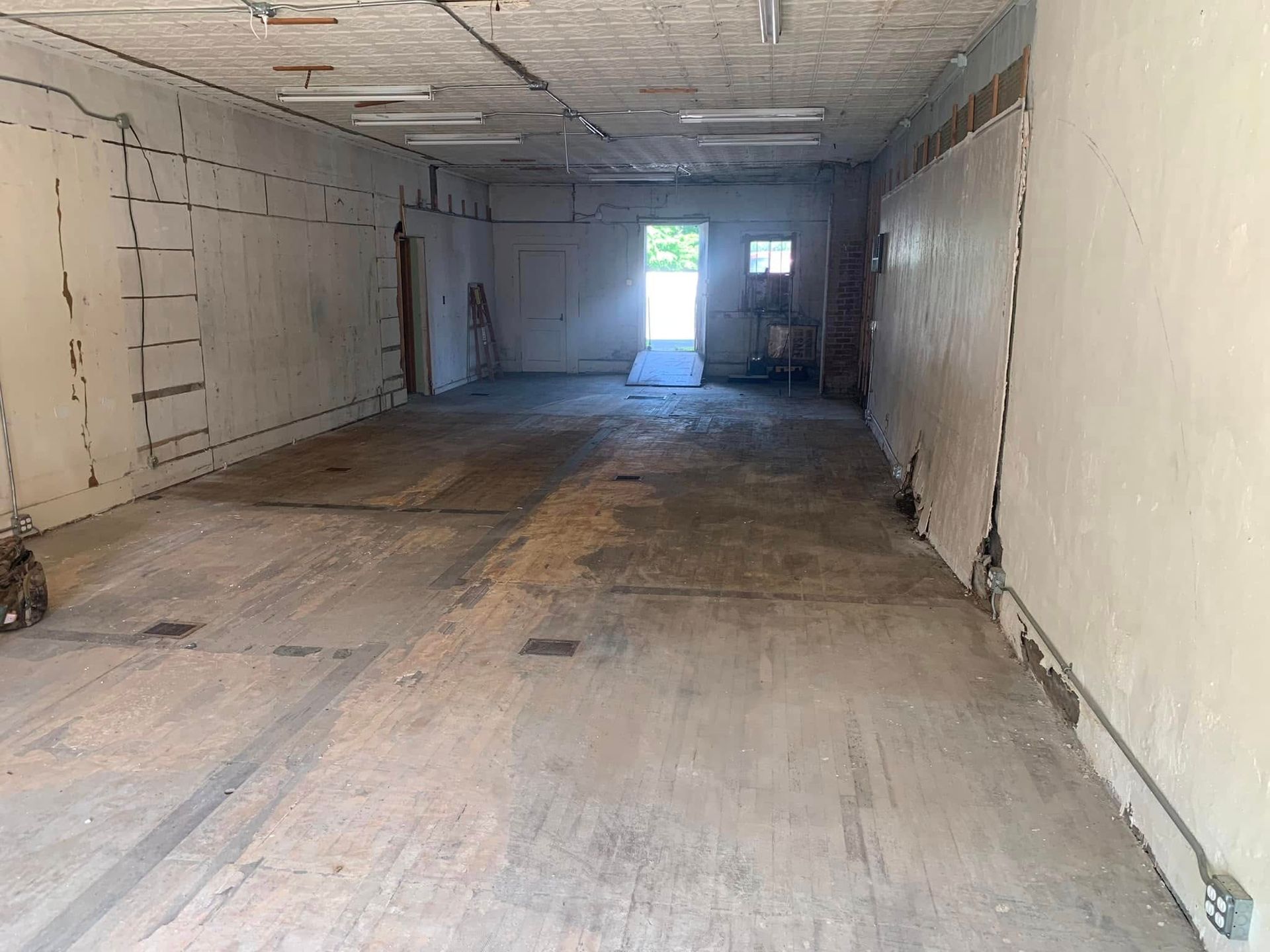 A large empty room with a door in the middle of it.