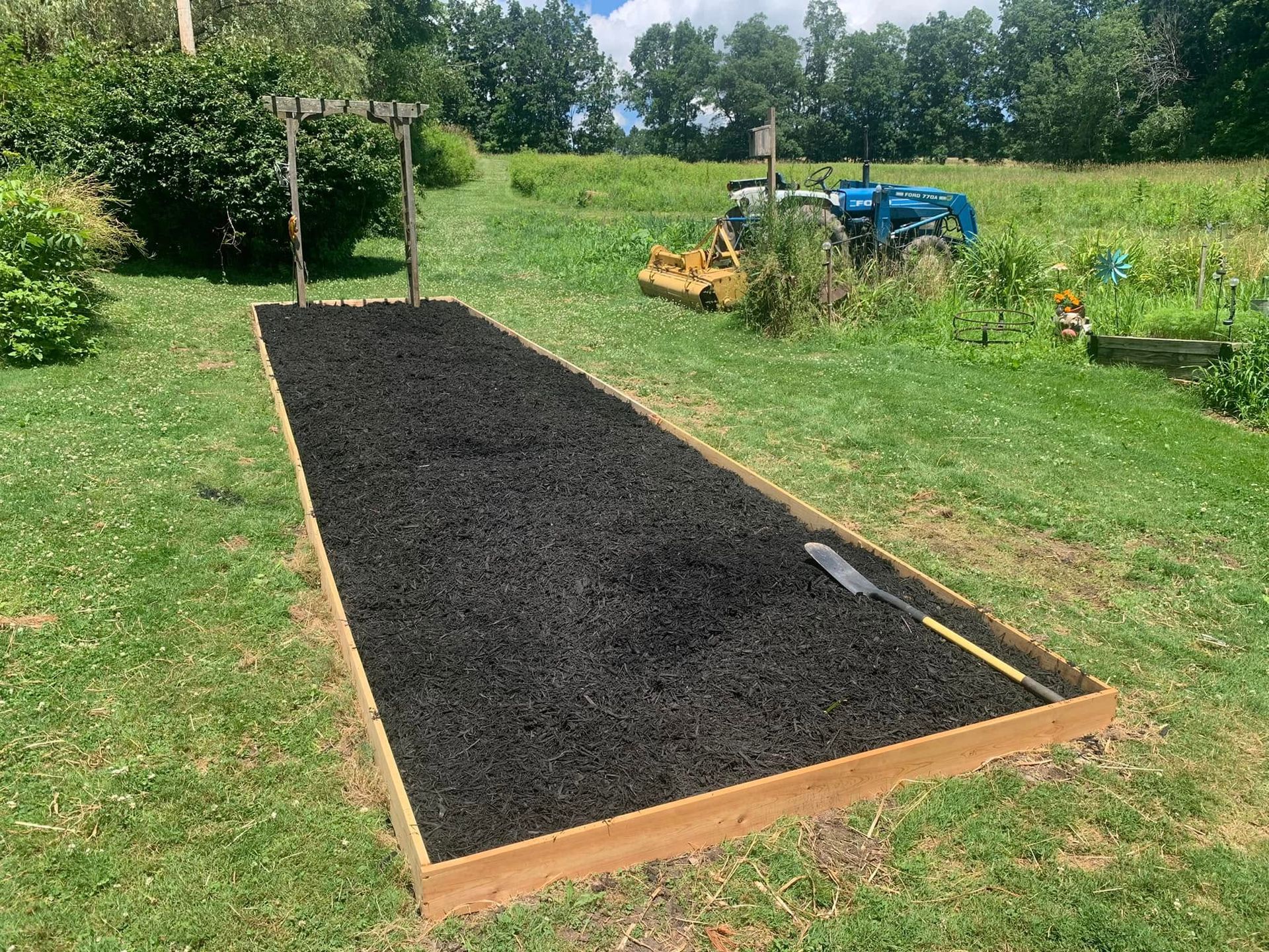 A tractor is parked in the background of a grassy field.