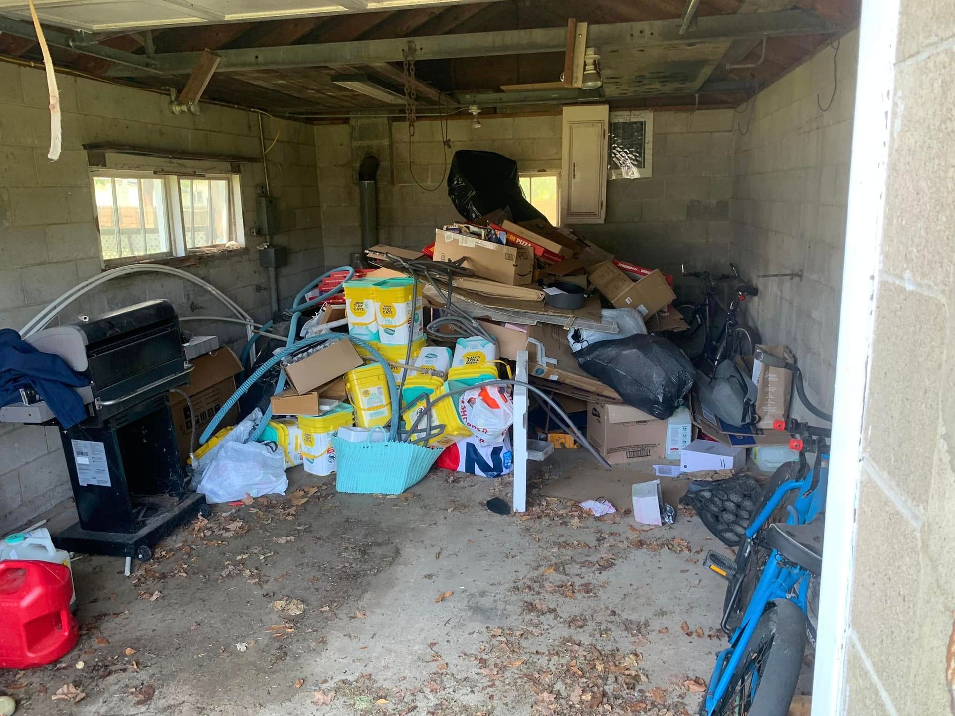 A garage filled with lots of trash and junk.