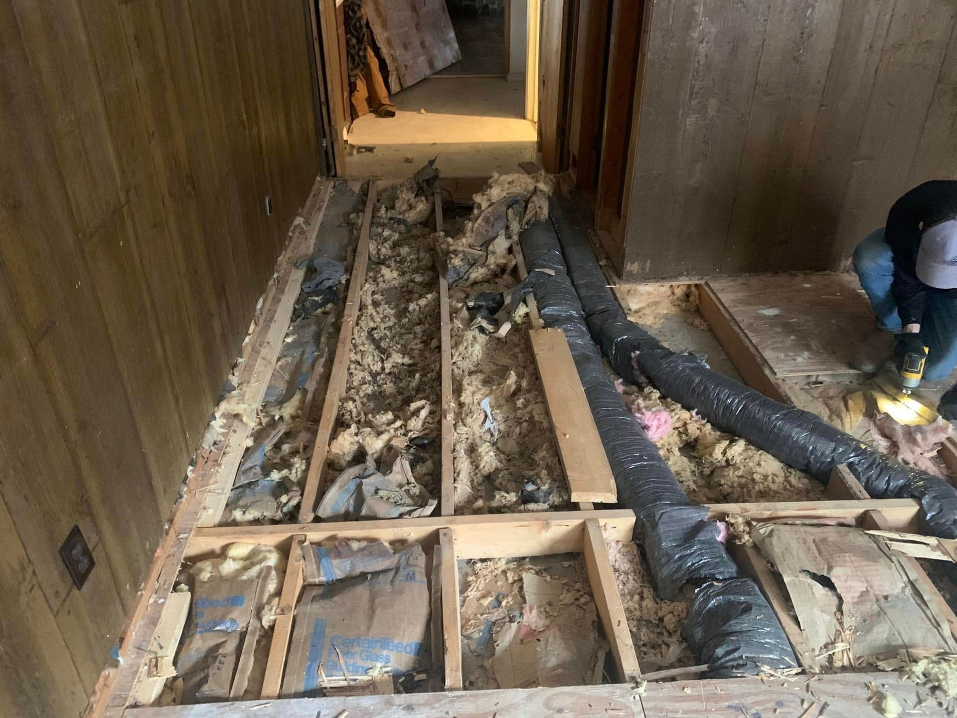 A person is working on the floor of a house.