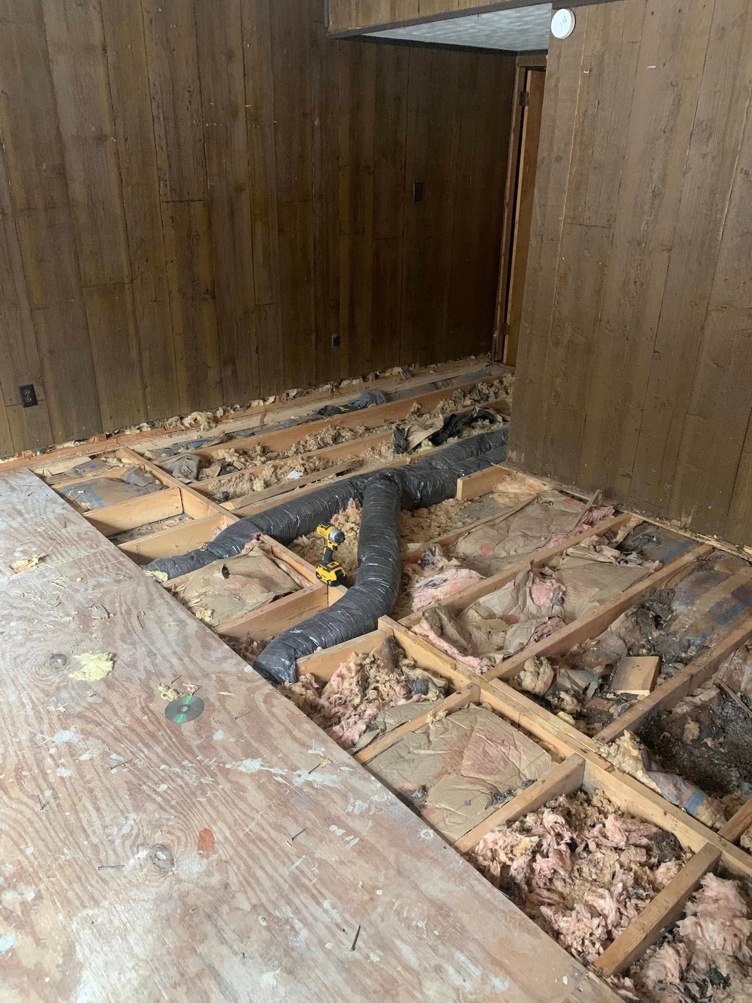 A room with a wooden floor and a hose in it.