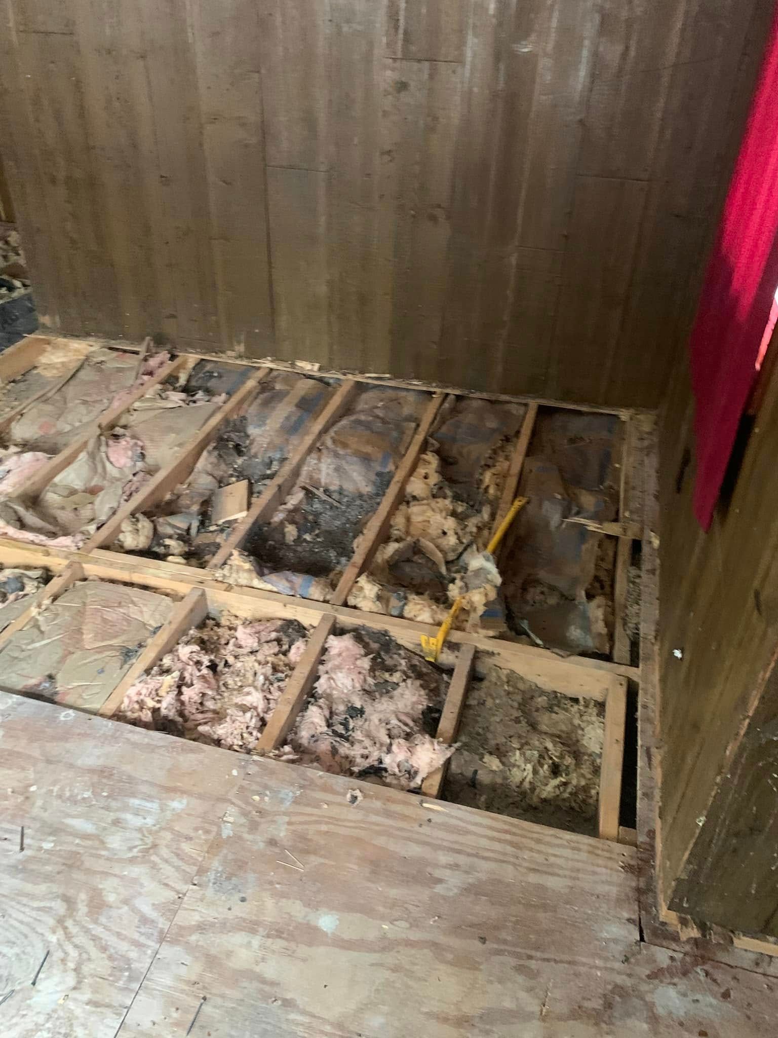 A room with a wooden floor and a hole in the floor.