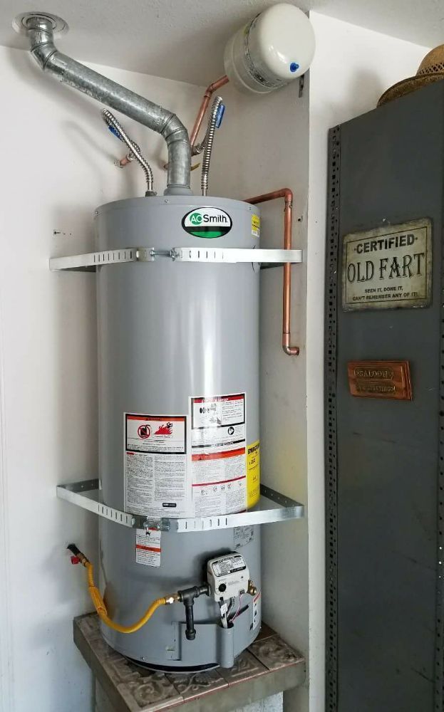 A.O. Smith water heater in a utility room, with vent pipe and copper water lines.