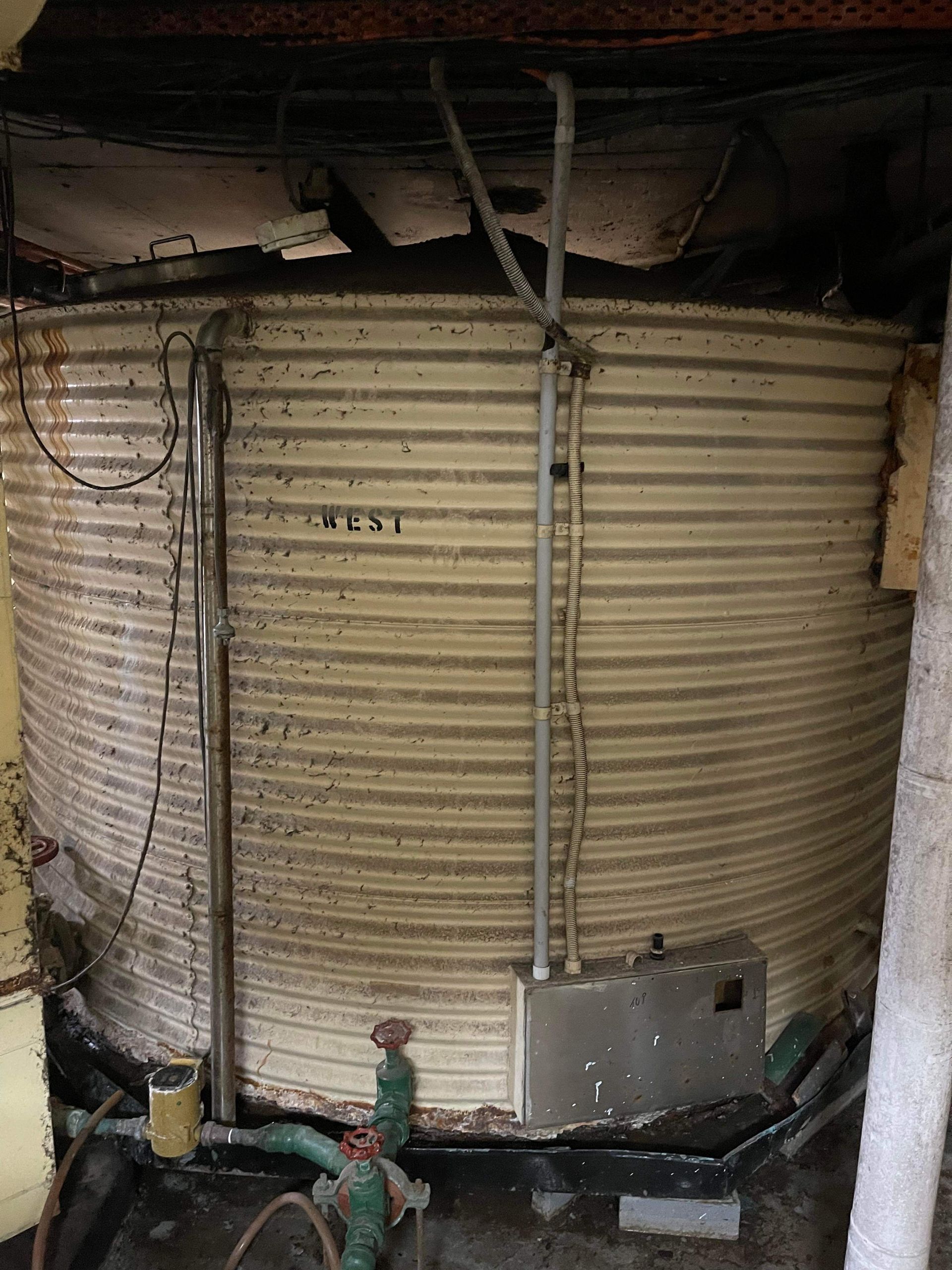 A large metal tank with the word nest written on it Demco In Currumbin Waters, QLD