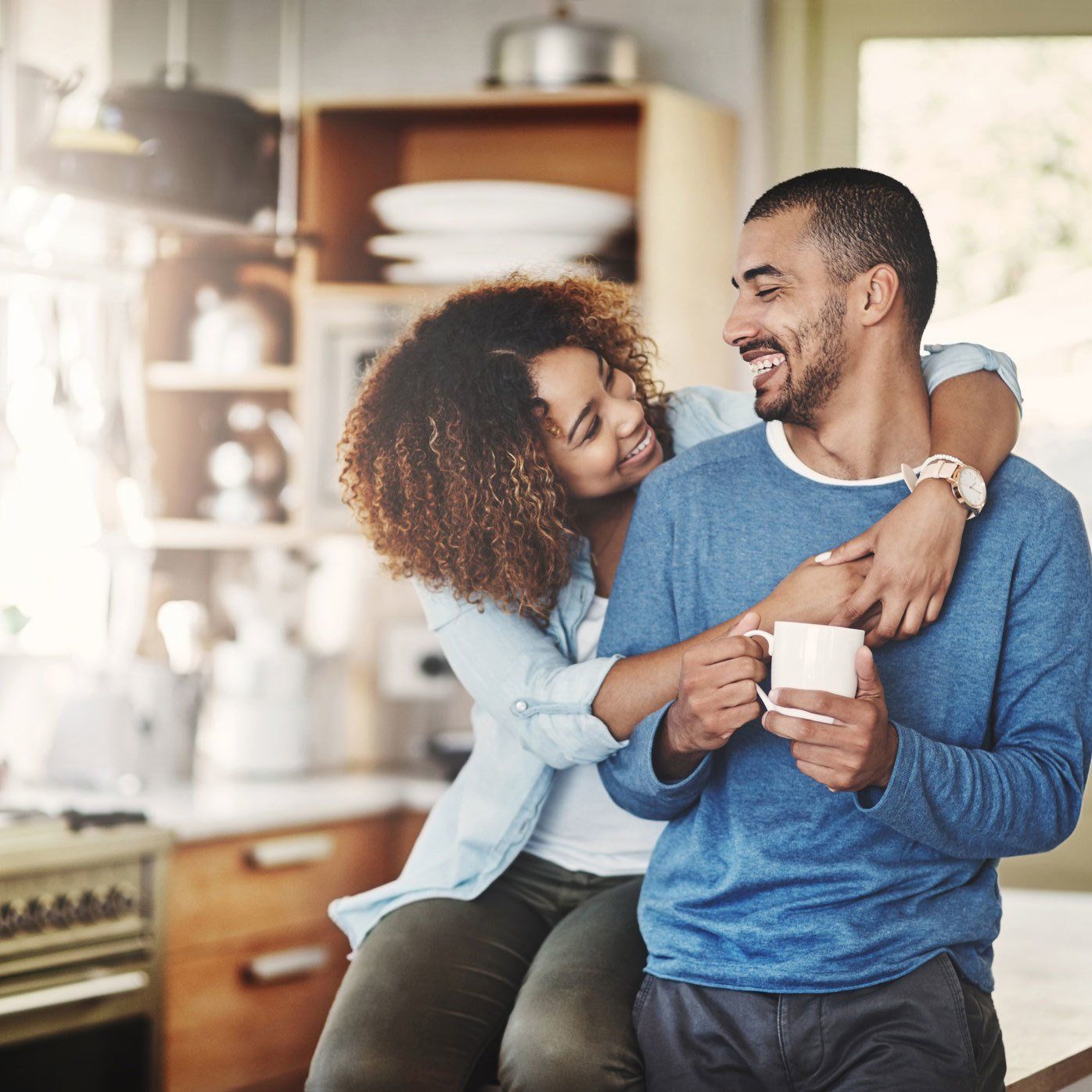 Shot of a happy young couple relaxing in the kitchen in the at home
