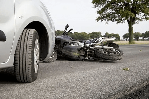 Sedan car and motorcycle accident