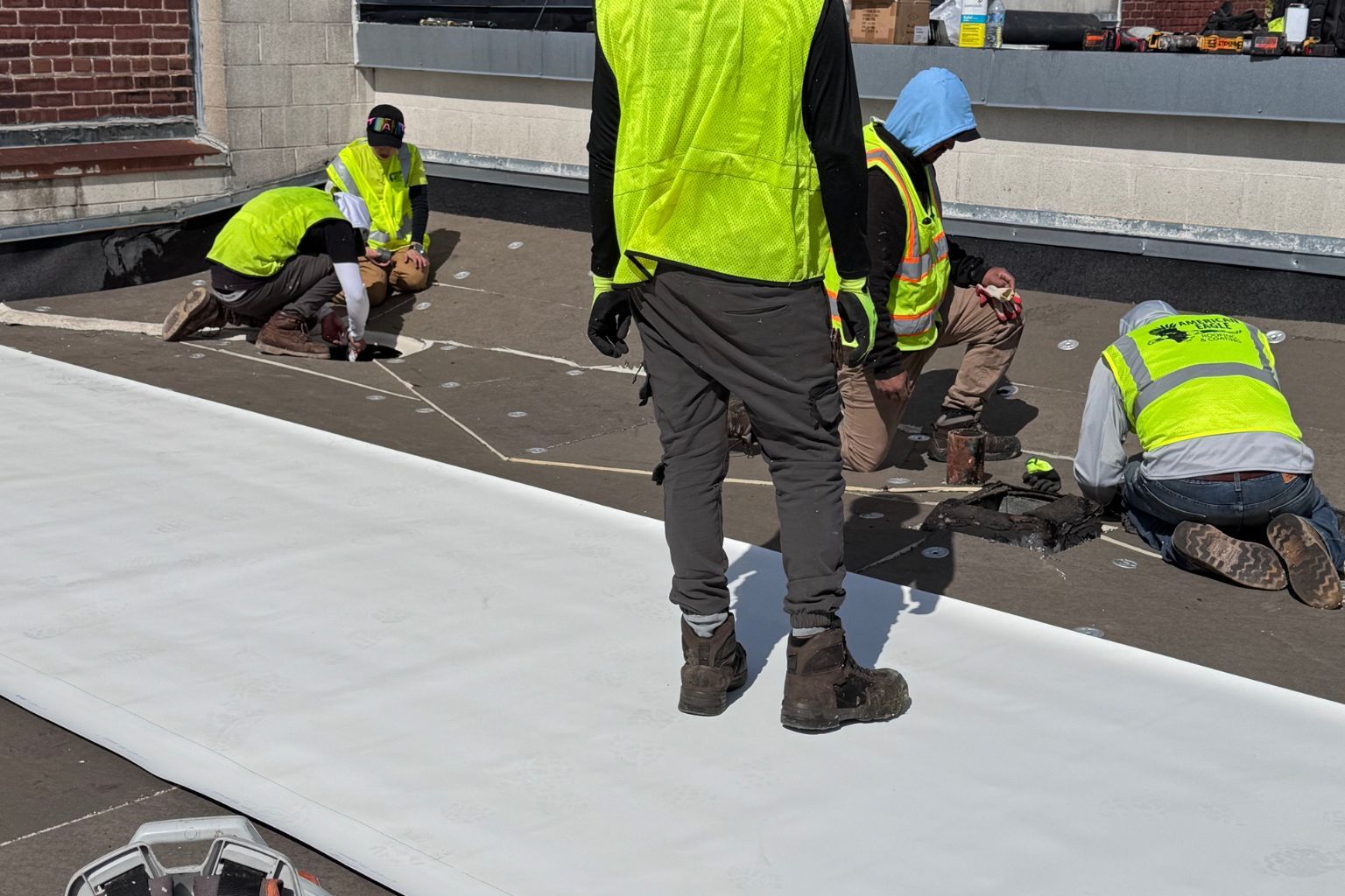 Side-by-side comparison of fabric-reinforced and single-ply membrane roofing system.