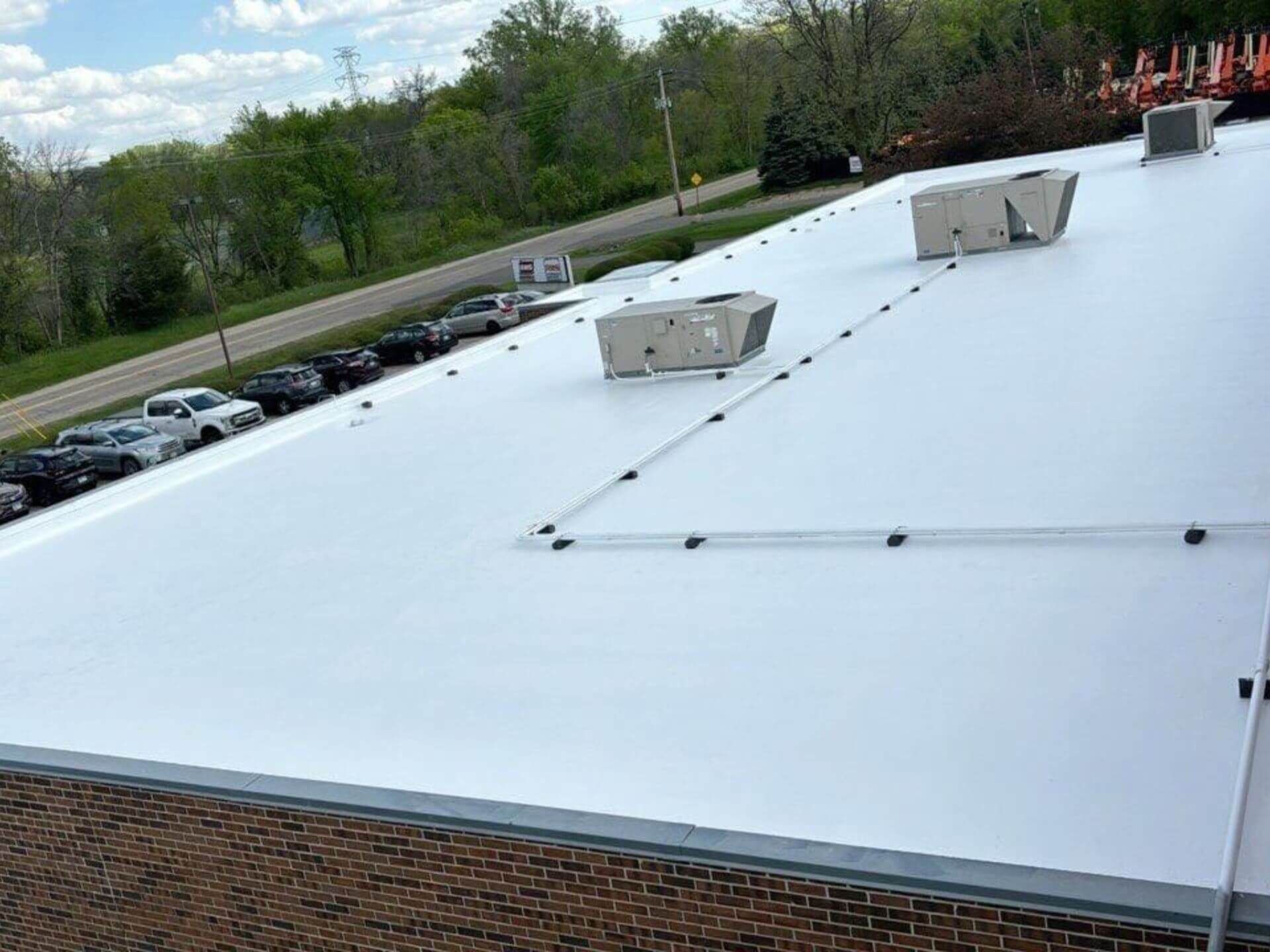 A roof with a pipe and a broom on it.