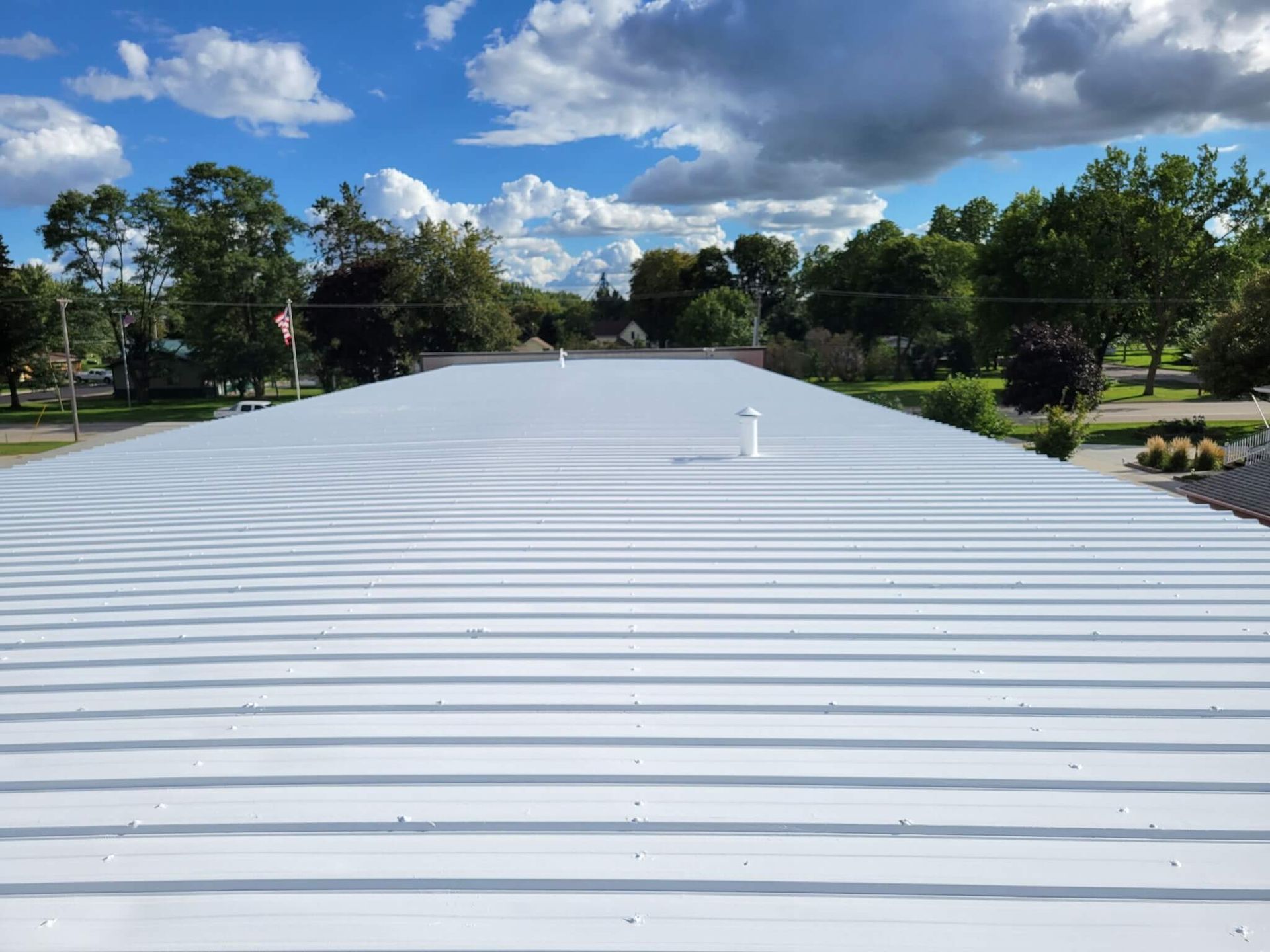A close up of a roof with a blue sky in the background.