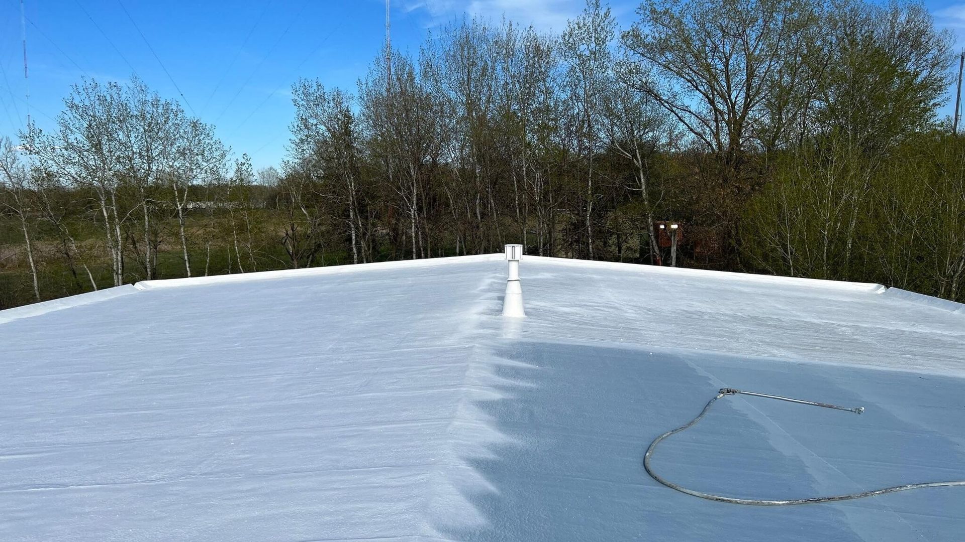 A white roof is being installed on top of a building.