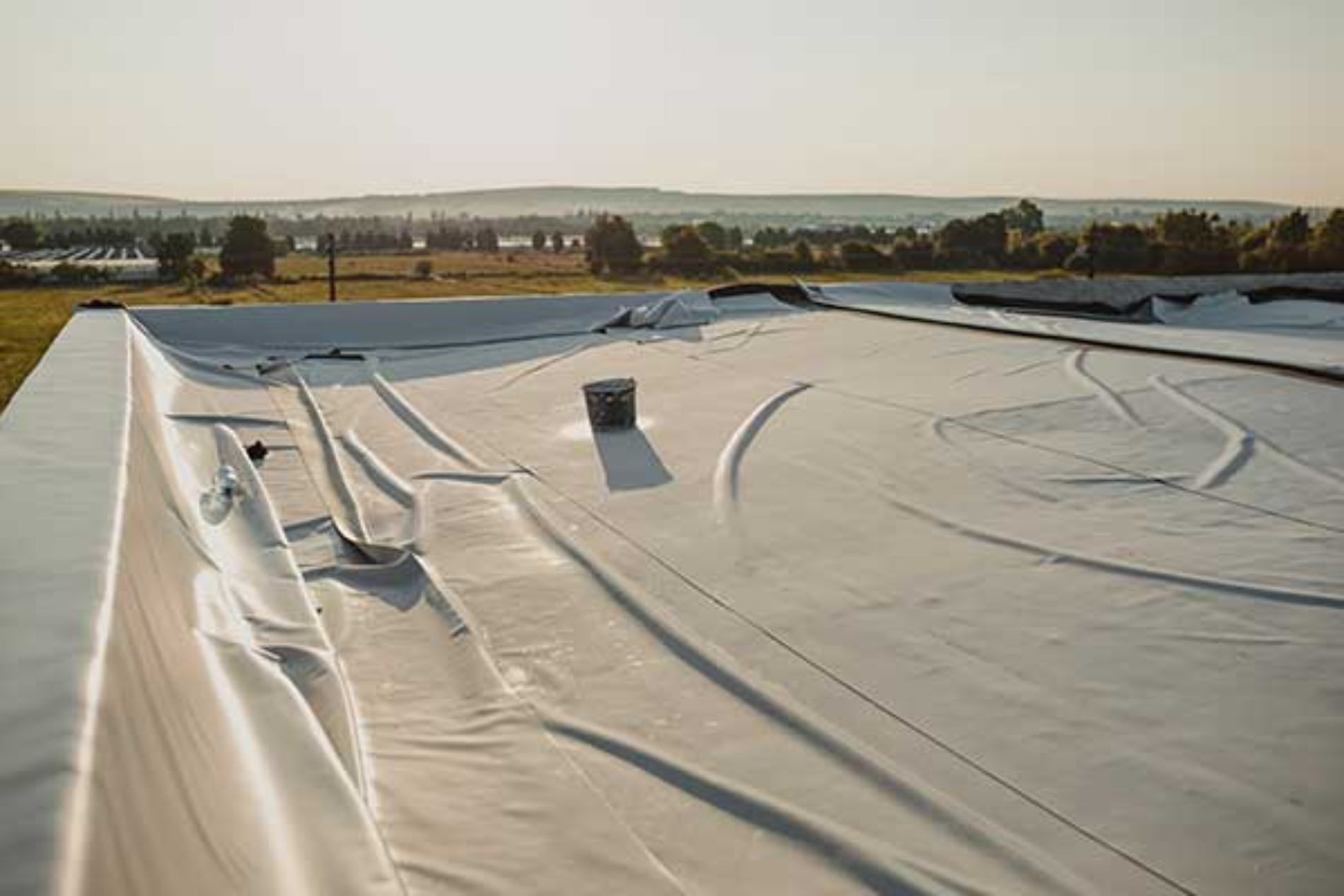 A white roof is being installed on top of a building.
