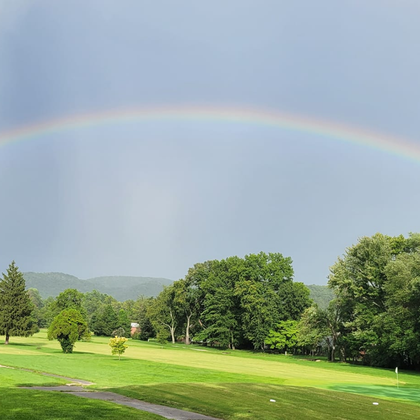 A vibrant rainbow arcs over a Berea, KY meadow, symbolizing the hope and renewal that Ark Covering & Restoration brings with their expert roofing services.  From roof replacement to insurance claim assistance, we've got you covered.