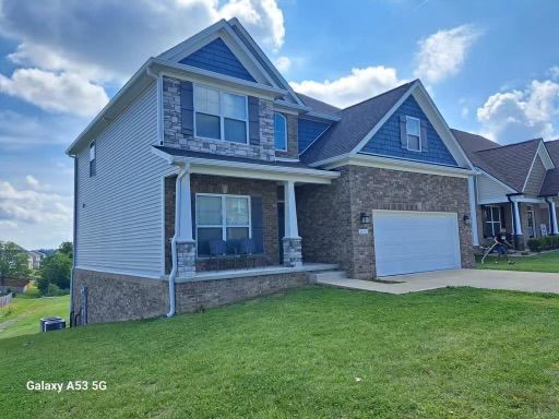 A large house with a blue roof and a white garage door.