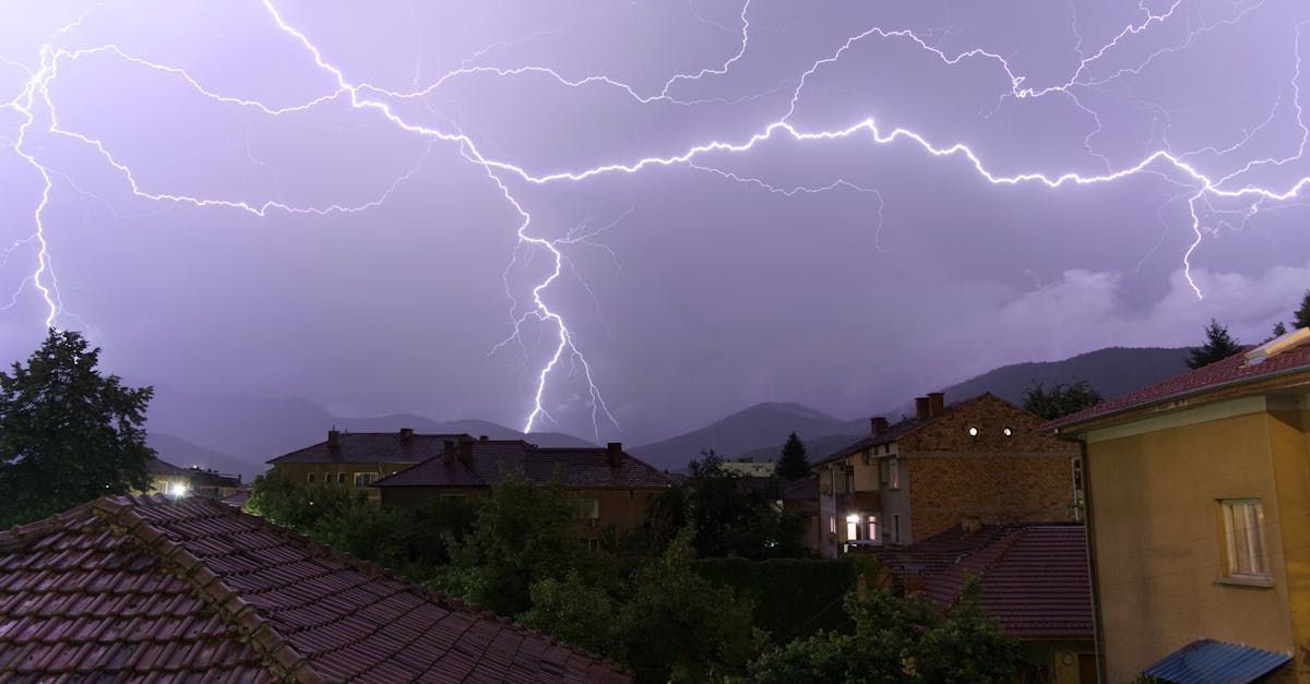 There is a lightning storm in the sky over a city.