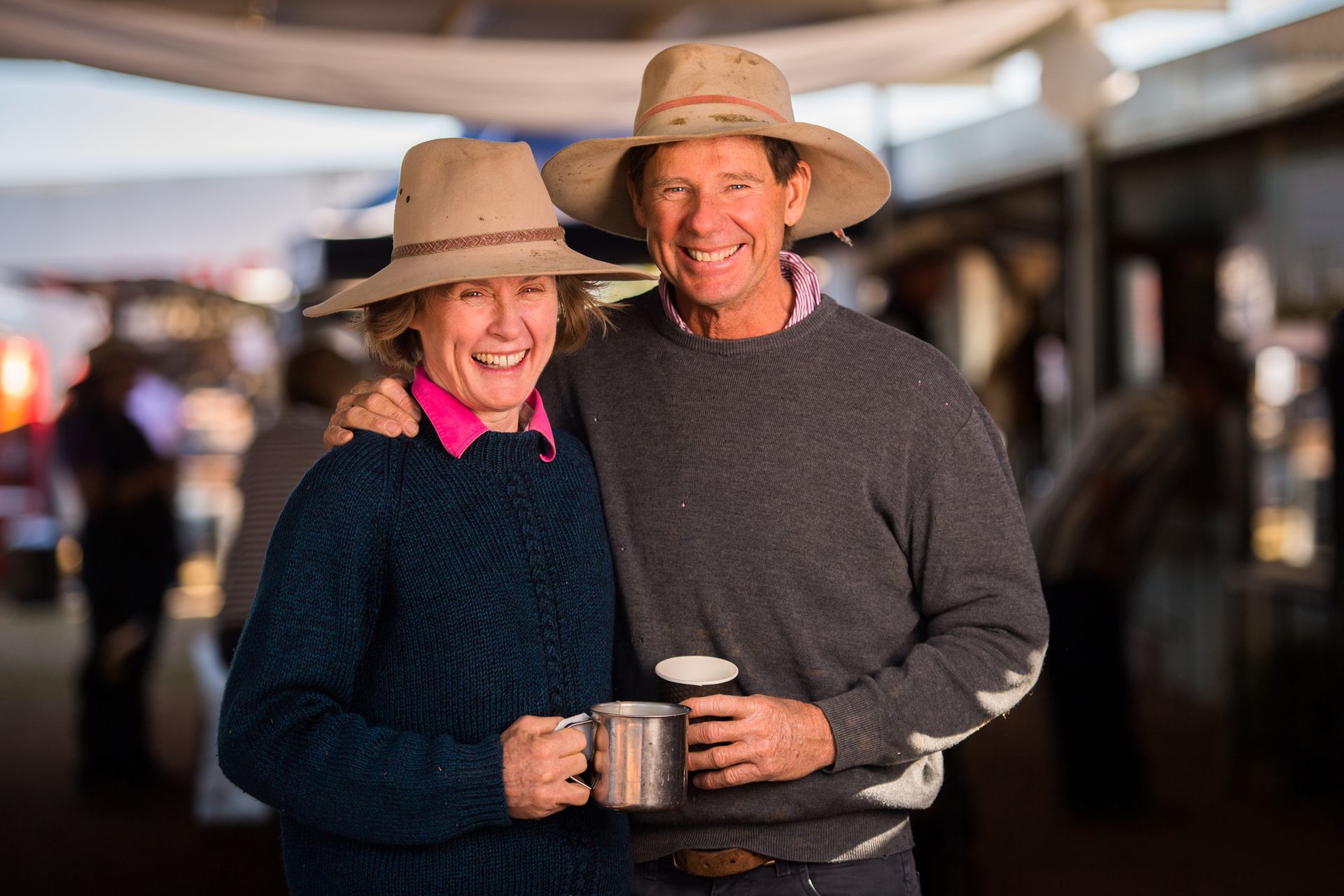 A man and a woman farmer with their coffees.