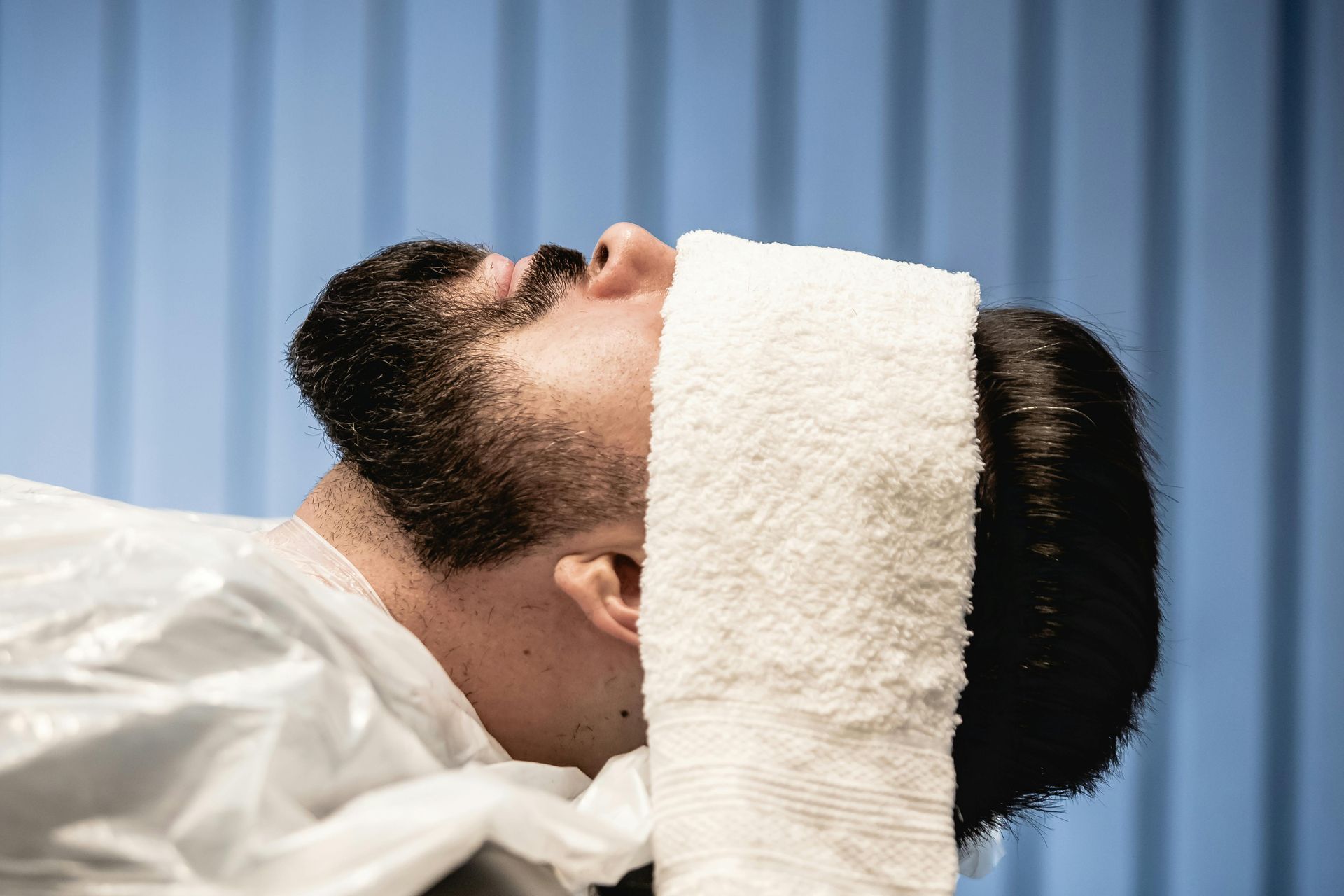 Woman relaxing in water with floating orange slices and fern leaves