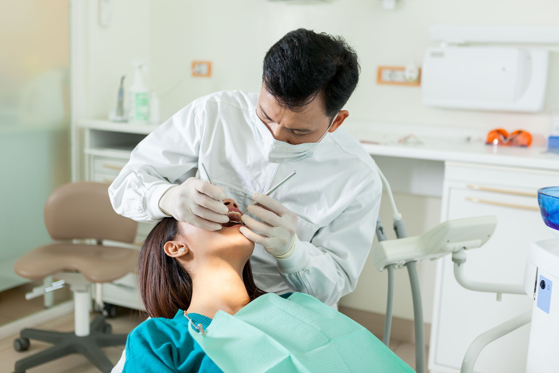 A dentist is doing a dental checkup on a young woman A dentist is doing a dental checkup on a young woman