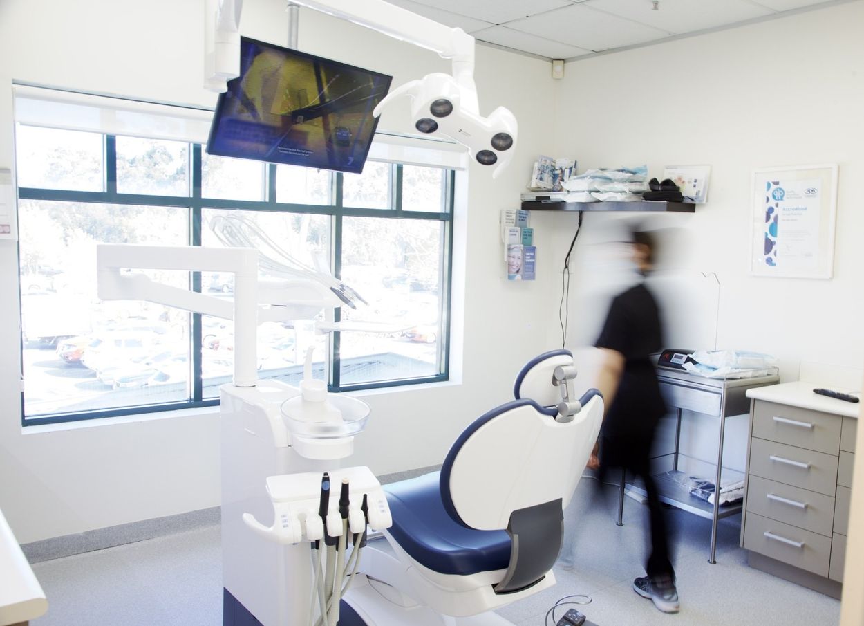A blurry picture of a dentist in a dental office