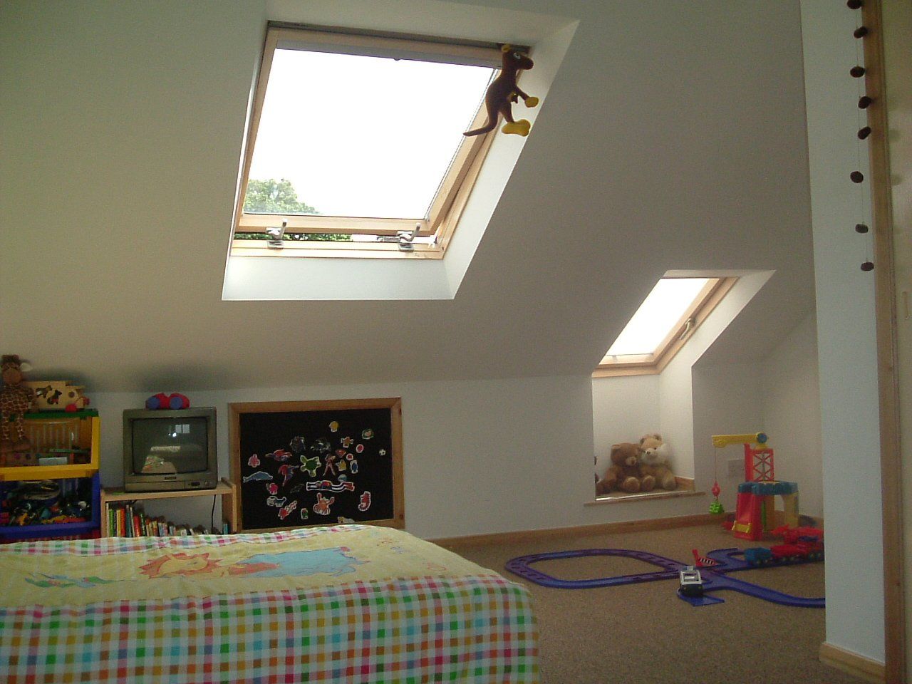 A child 's room with a monkey hanging from the ceiling