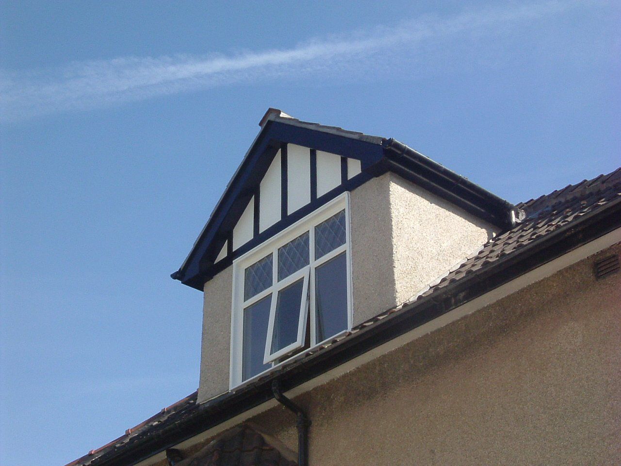 A house with a window on the top of it