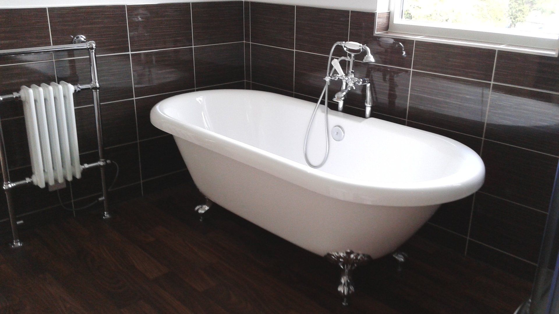 A bathroom with a bathtub and a radiator
