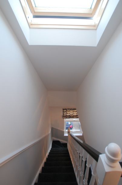 A staircase with a skylight on the top of it