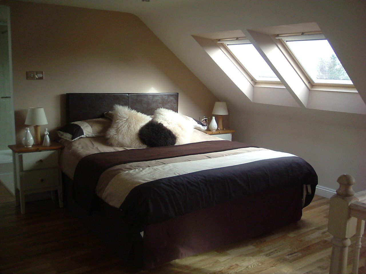 A Loft bedroom with a king-size bed and three skylights