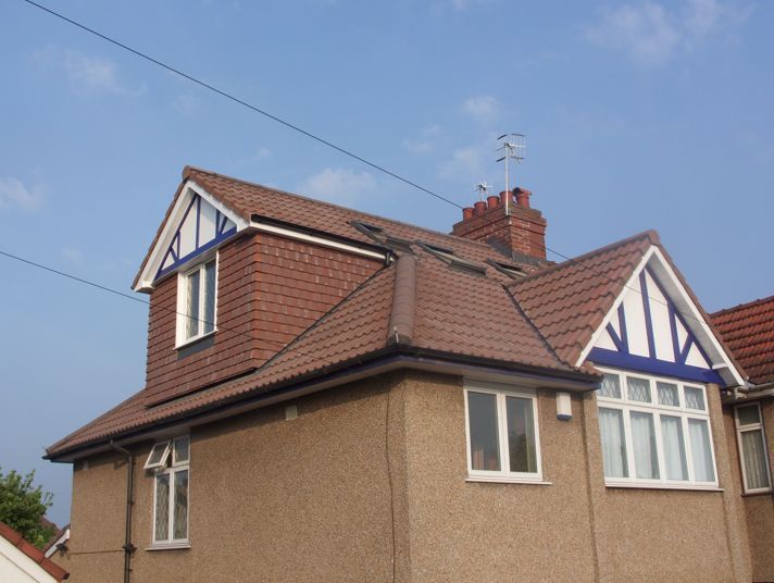 A house with a brown roof and white windows