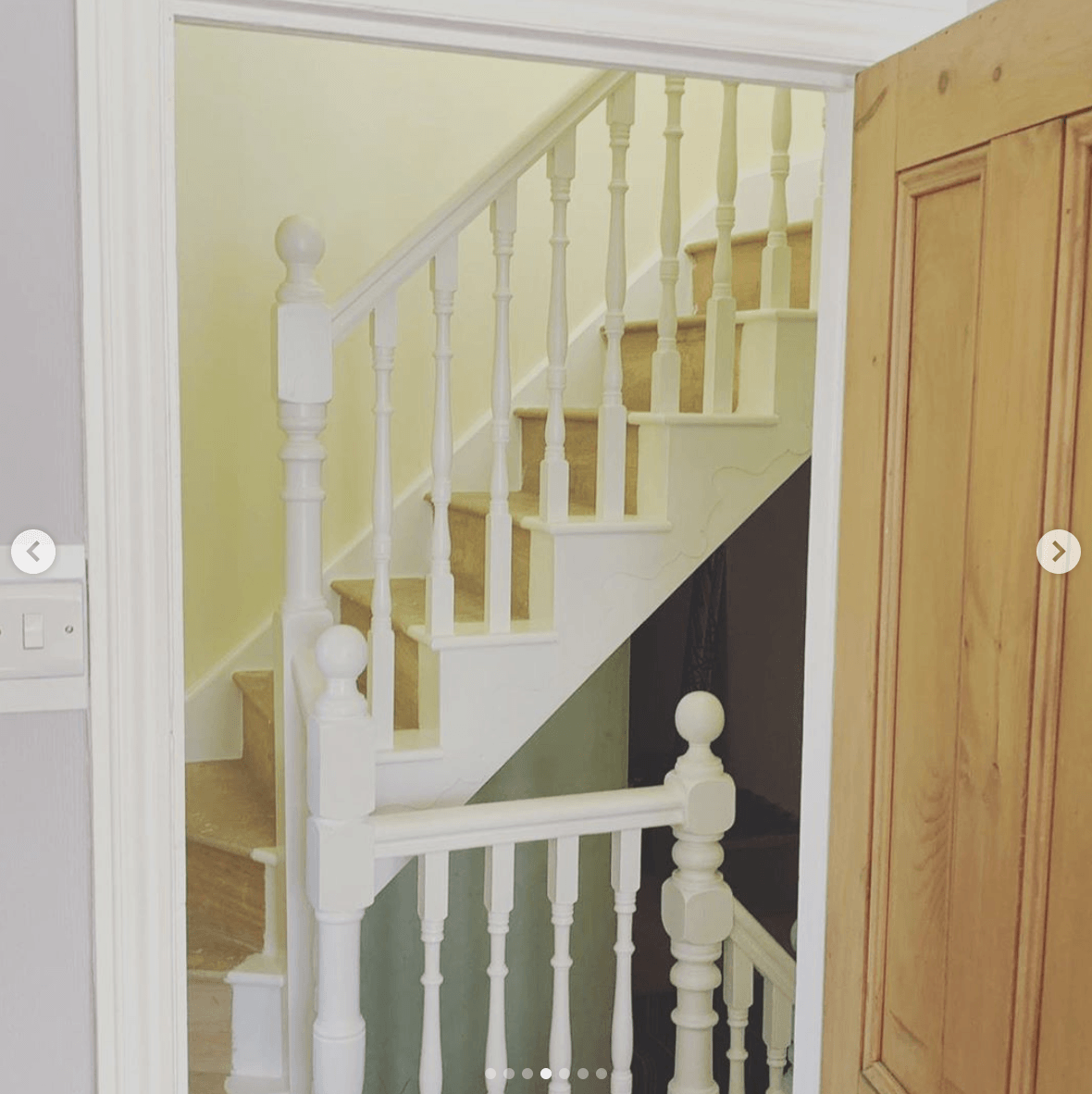 A picture of a staircase with a white railing